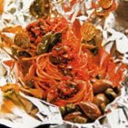Spaghetti with green olive and caper sauce baked in foil